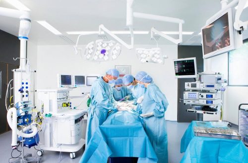 Surgical team performing a minimally invasive proctology procedure in a modern UAE operating theatre